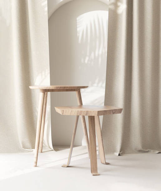 istock Two wooden geometric shape brown chairs with different height in sunlight, leaf shadow on beige curtain, wall 1957013308