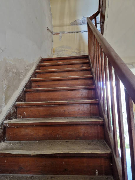 istock Old wooden stairs in a hallway 1957029286