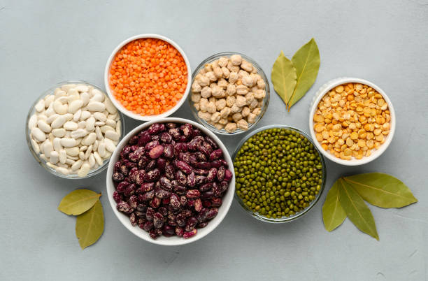 istock Various sources of vegetable protein: beans, lentils, peas, chickpeas, mung bean in bowls. A healthy balanced diet for vegans and vegetarians. Gray stone background. 1957054175