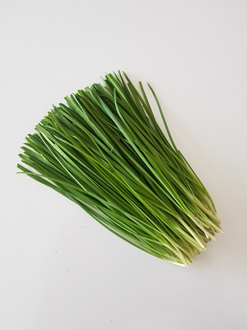 A bunch of chives isolated on a white background.