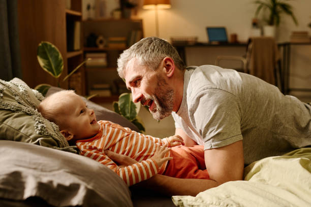 istock Mature man playing with sweet baby son 1957076177