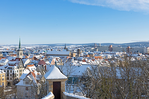 view from Petersberg mountain over the snow covered roofs of Erfurt in Thuringia