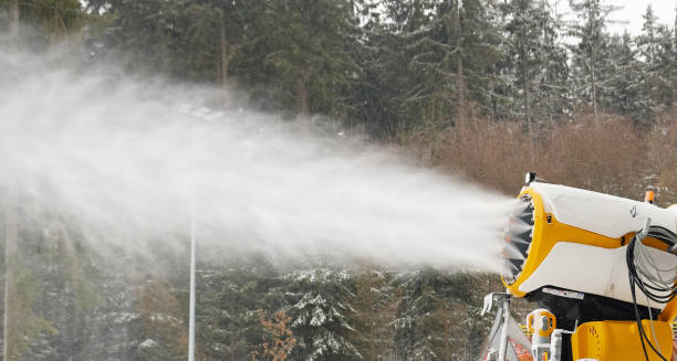 snow cannon makes artificial snow. snowmaking systems sprays water to produce snow. preparation of ski track for skiing, winter sport. machine making snow. - mountain winter season machine snow making machine ストックフォトと画像