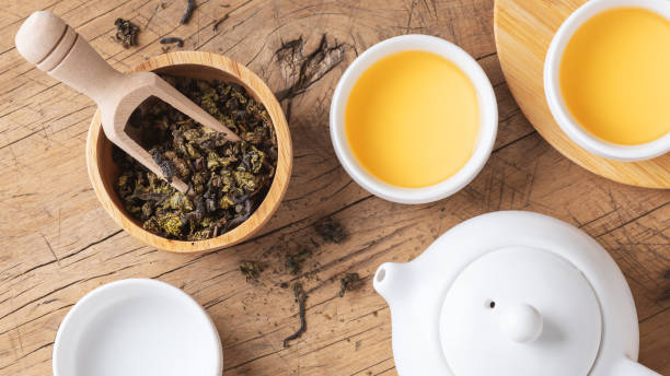 istock Tea leaves with teapot and tea cup on wood table 1957122192