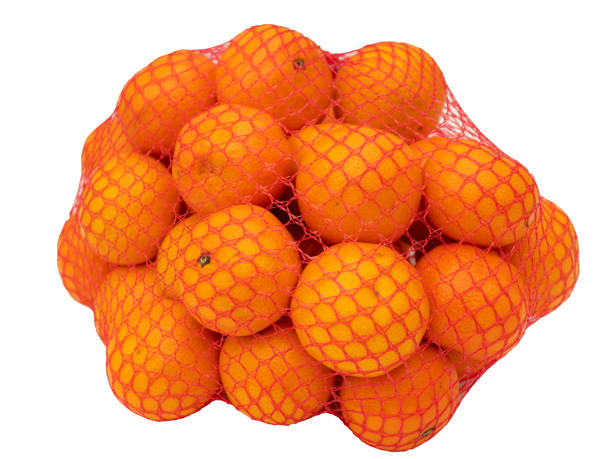 istock Net with citrus fruits isolated on white background 1957129885