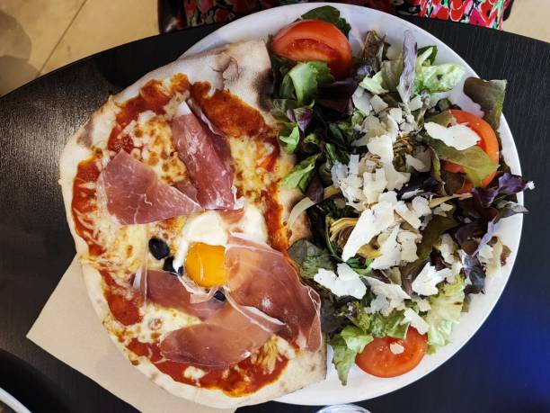 istock Famous dish of half pizza-salad 1957136707