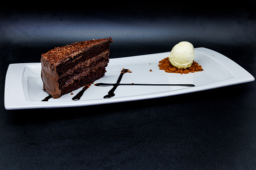 Dessert vanilla parfait ice cream with berries, blood orange and chocolate cake served  in Michelin Star gourmet Restaurant