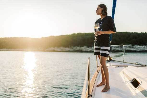 istock Woman drinking wine on sailboat 1957163908