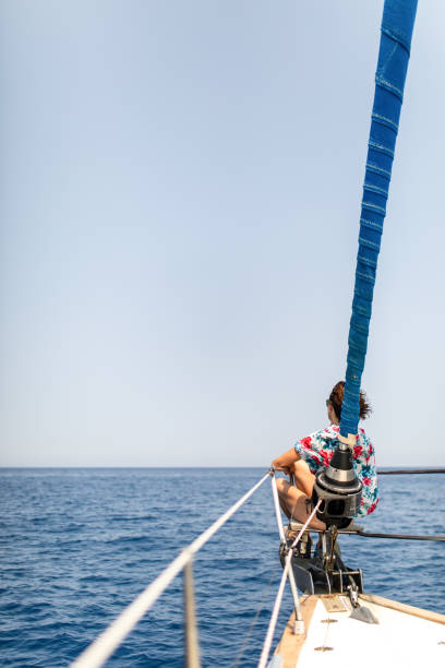 woman relaxing on a sailboat bow - sailing light wind nautical vessel imagens e fotografias de stock