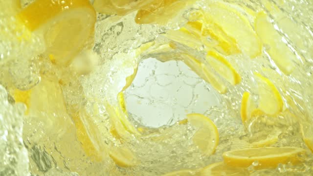 Super Slow Motion Shot of Lemon Slices and Water Rotating in Wave at 1000fps.