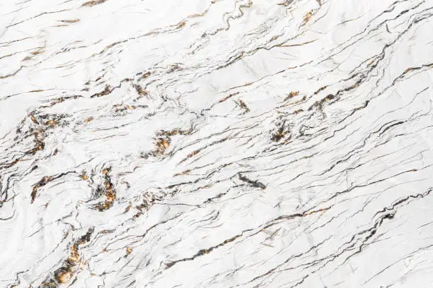 Photo of White marble texture with dark and brown layers