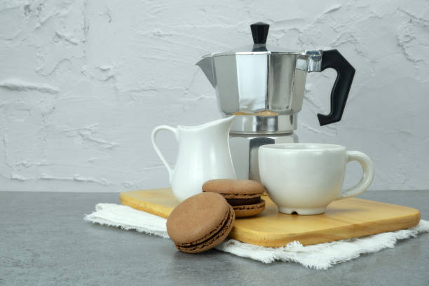 istock Coffee and macarons and mokapot on tray on table. Copyspace for your text 1957164579