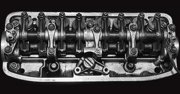 Close up of part of a car engine. Cylinder heads. Valve springs. Engine block. Rocker shaft.