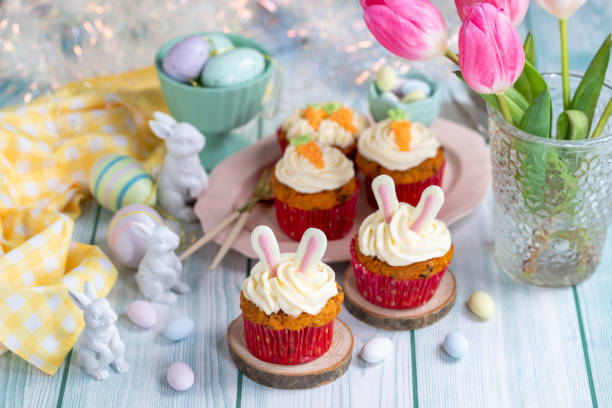 istock Easter cupcake with cream cheese frosting decorated with carrots and bunny ears. 1957194964