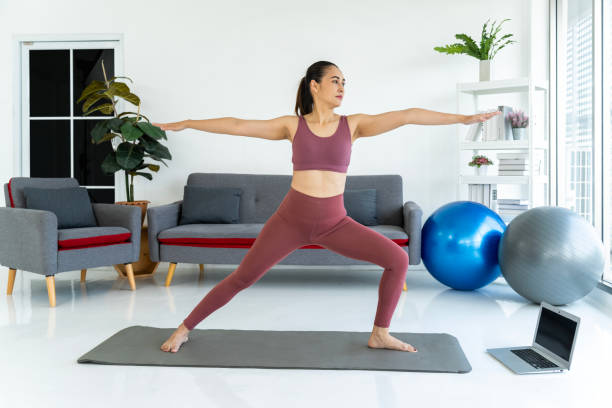 istock Beautiful Woman Practicing Yoga at Home 1957194970
