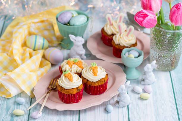 istock Easter cupcake with cream cheese frosting decorated with carrots and bunny ears. 1957195367