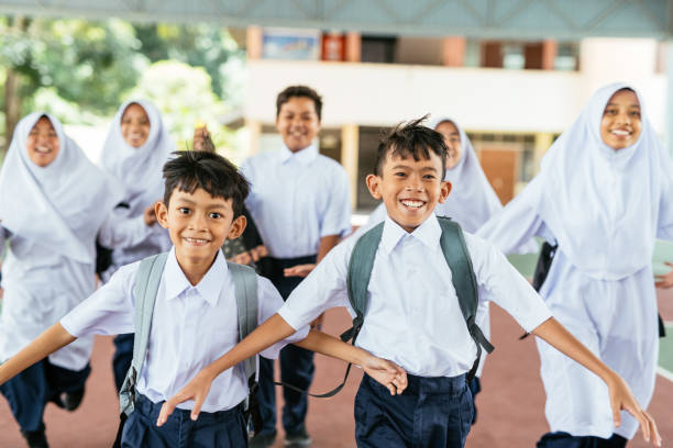 istock Primary school students and pupils in the school yard when the school is over 1957201588