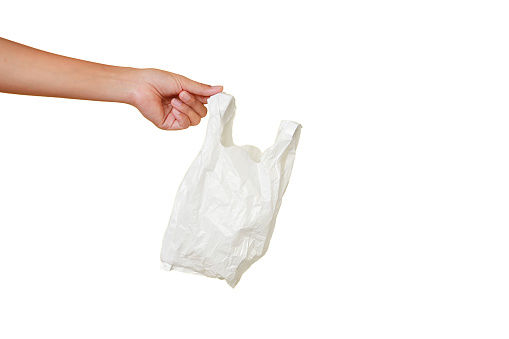 Close-up people hand holding a white thin polythene plastic bag isolated over white background.