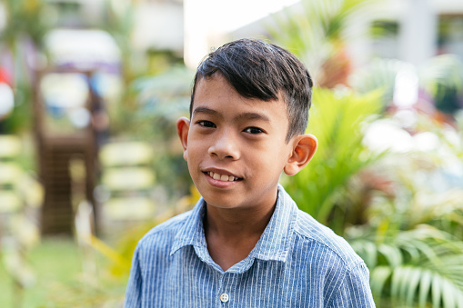 Elementary student in South East Asia, Looking at camera and smiling