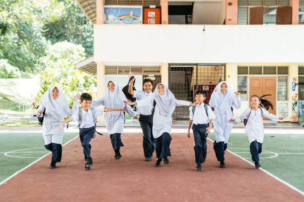 istock Primary school students and pupils in the school yard when the school is over 1957203747