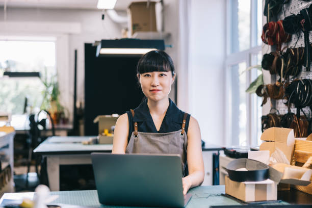 istock Japanese leathercraft studio owner works with a laptop 1957213647