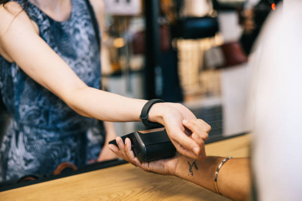 istock Female customer making a contactless payment with smartwatch 1957214188