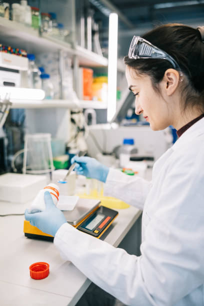 istock Female scientist weighing chemicals on a digital scale 1957216924
