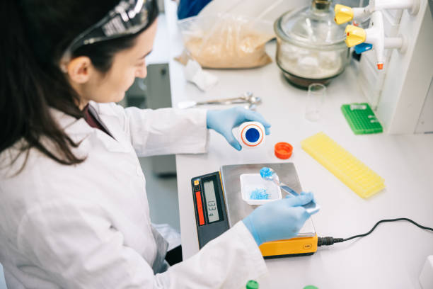 istock Female scientist weighing chemicals on a digital scale 1957216929