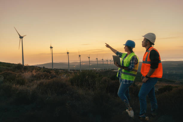 istock Maintenance engineer team working in wind turbine farm at sunset 1957220662