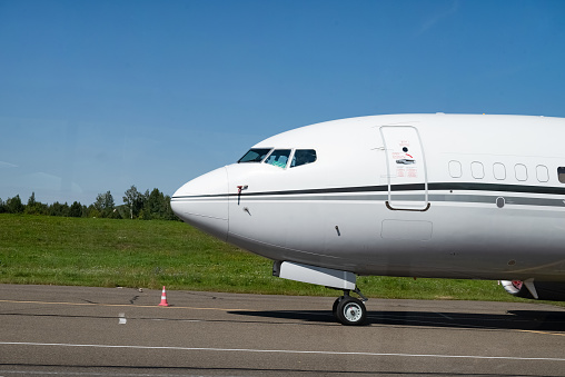 large passenger plane was taxiing for take-off in summer