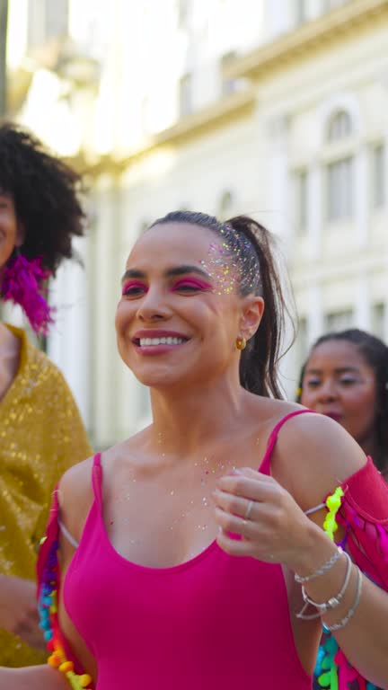 Friends dancing and laughing in brazilian Carnival.