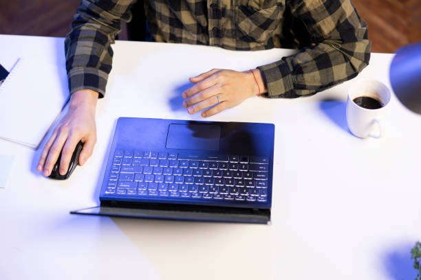 Person using mouse to browse on laptop