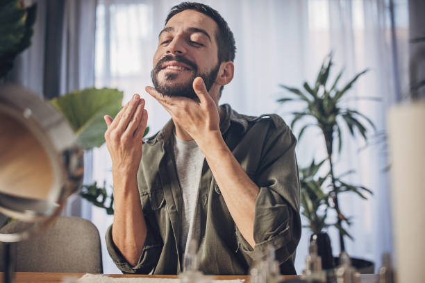 Man applying a cream on his face during his facial treatment routine