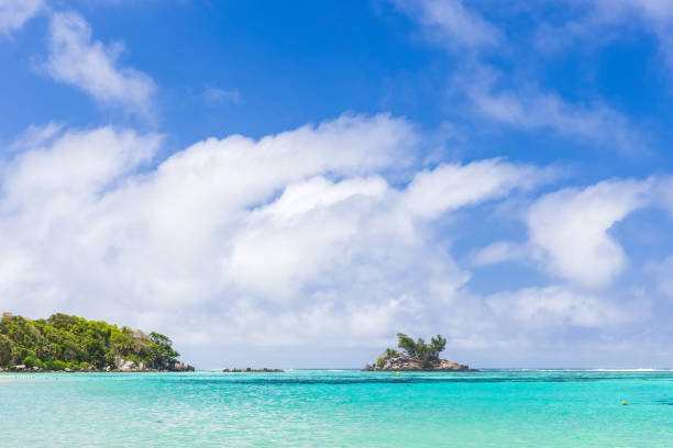 istock Anse Royale, Seychelles. Coastal view with small island under blue sky 1957252606