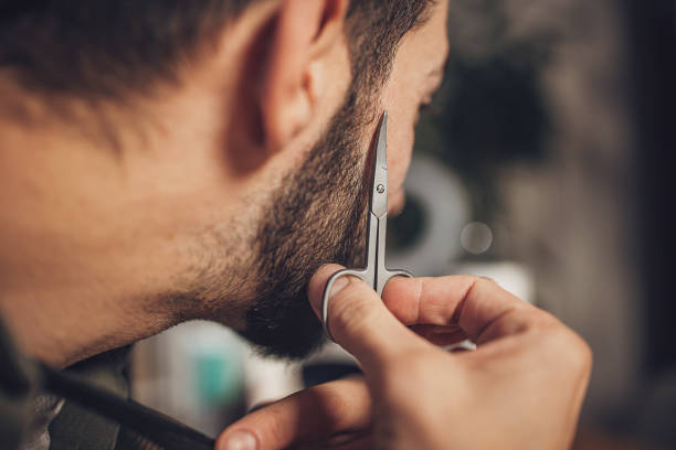 Man grooming his beard at home