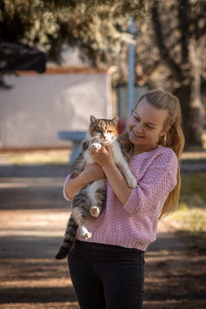 istock Young woman holding her cat 1957262308