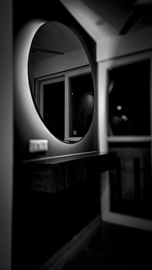 Strike a dramatic pose with this sleek, black and white round mirror. Its backlit design adds depth and dimension to any space, making it a statement piece for modern interiors. (Keywords: modern, black and white, round mirror, backlit, statement piece, interior design)