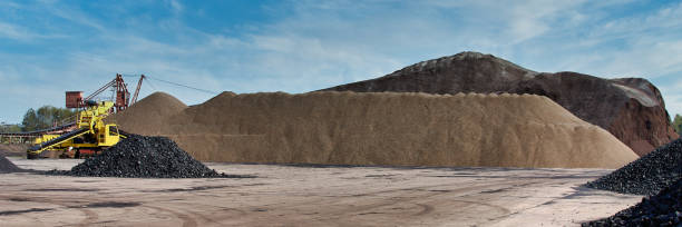 istock Storage of coal, lignite and ecological coconut shell briquettes. Coal loader. Heaps of coal. 1957272055