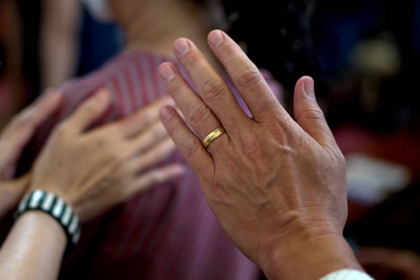 istock Human hands praying raising and caring together at Church. 1957307745