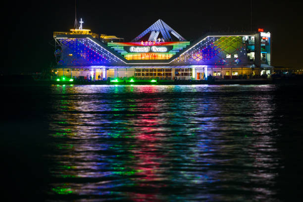 Pattaya, Thailand - 17 December, 2023: night view on colorful illumination of Oriental Ocean Carnival ship. Tourist floating vessel with restaurant and entertainment shows off the coast of Pattaya