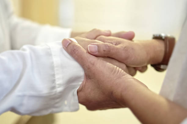 istock Human hands praying and caring together at Church. 1957319248