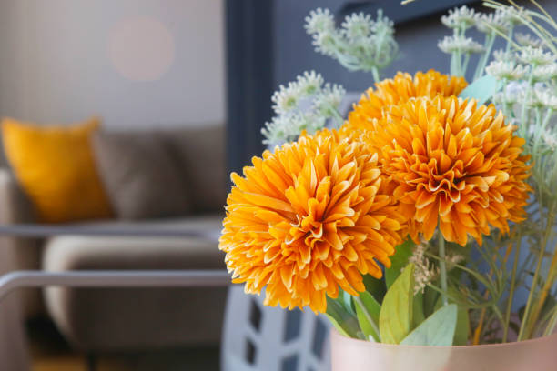 istock Nice orange flowers in vase on the balcony table, home decor concept 1957330875