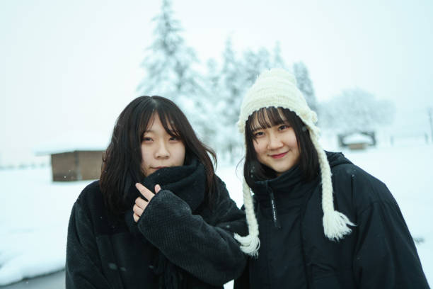 Two best friends walking together in the snow