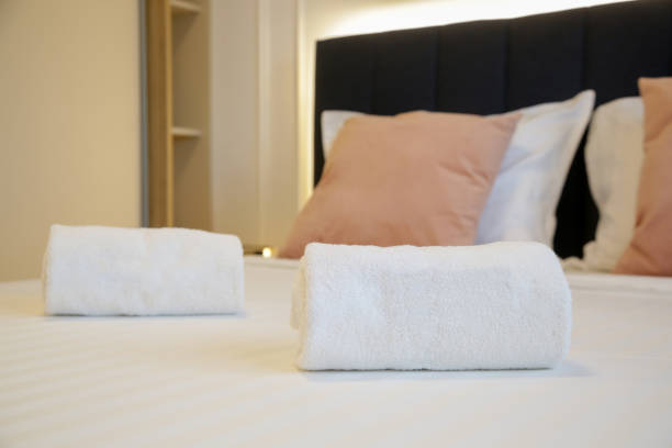 istock Clean towels on bed in modern interior bedroom 1957338496