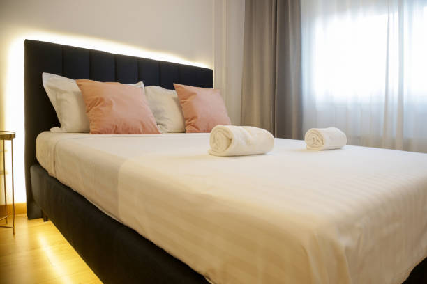 istock Clean towels on bed in modern interior bedroom 1957338497