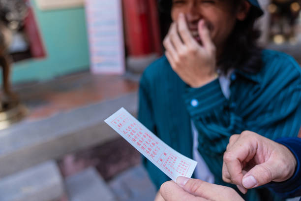 Unrecognisable Asian person smiling while is reading a message from God