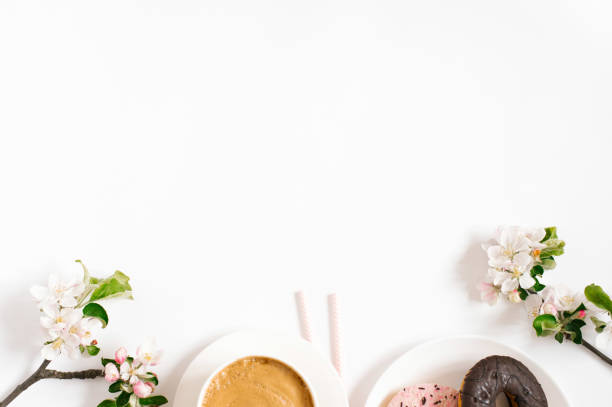 istock Stylish flat lay with cappuccino cup, apple blossoms, donuts on a white background with space copying. Morning breakfast or coffee break 1957349345