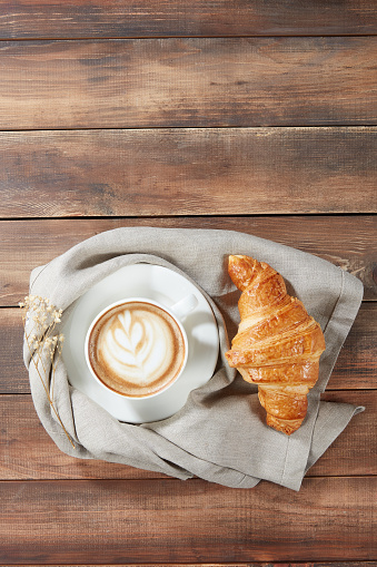 Top View Of Cappuccino And Croissant Over Table