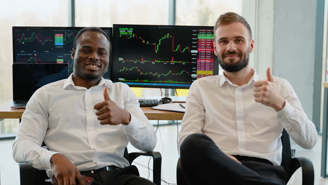 Portrait of two diverse men traders at office