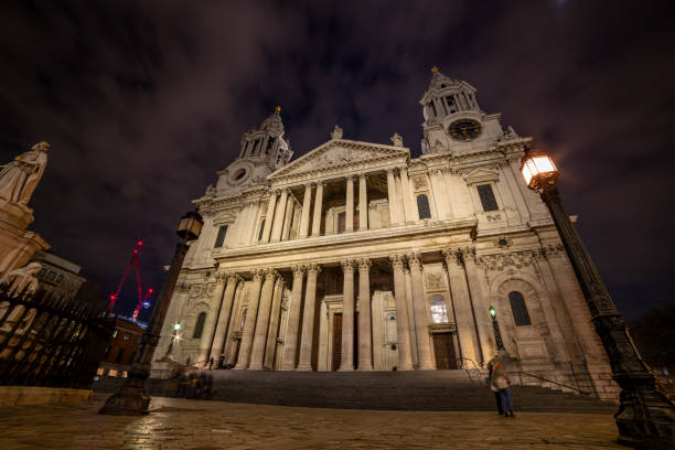 This striking church tower in London is beautifully lit against the night sky, highlighting its detailed stonework and Gothic architecture. The scene presents a timeless view of the city in 2024.